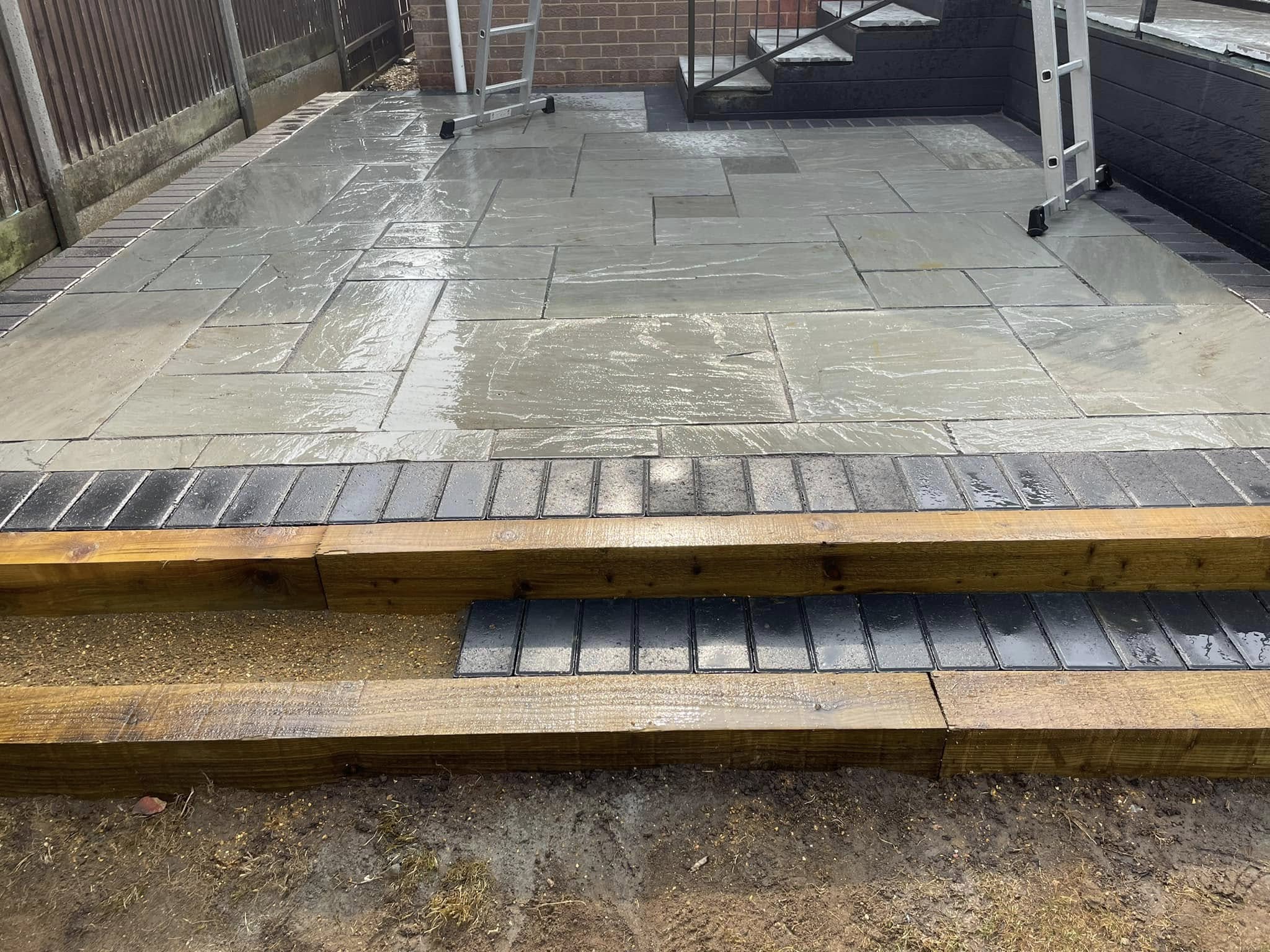 Raised porcelain patio with timber sleepers